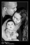 Mum and Dad kissing baby girl